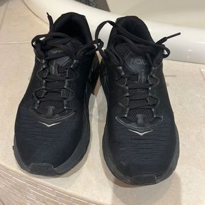 HOKA (7.5) all black athletic shoes.